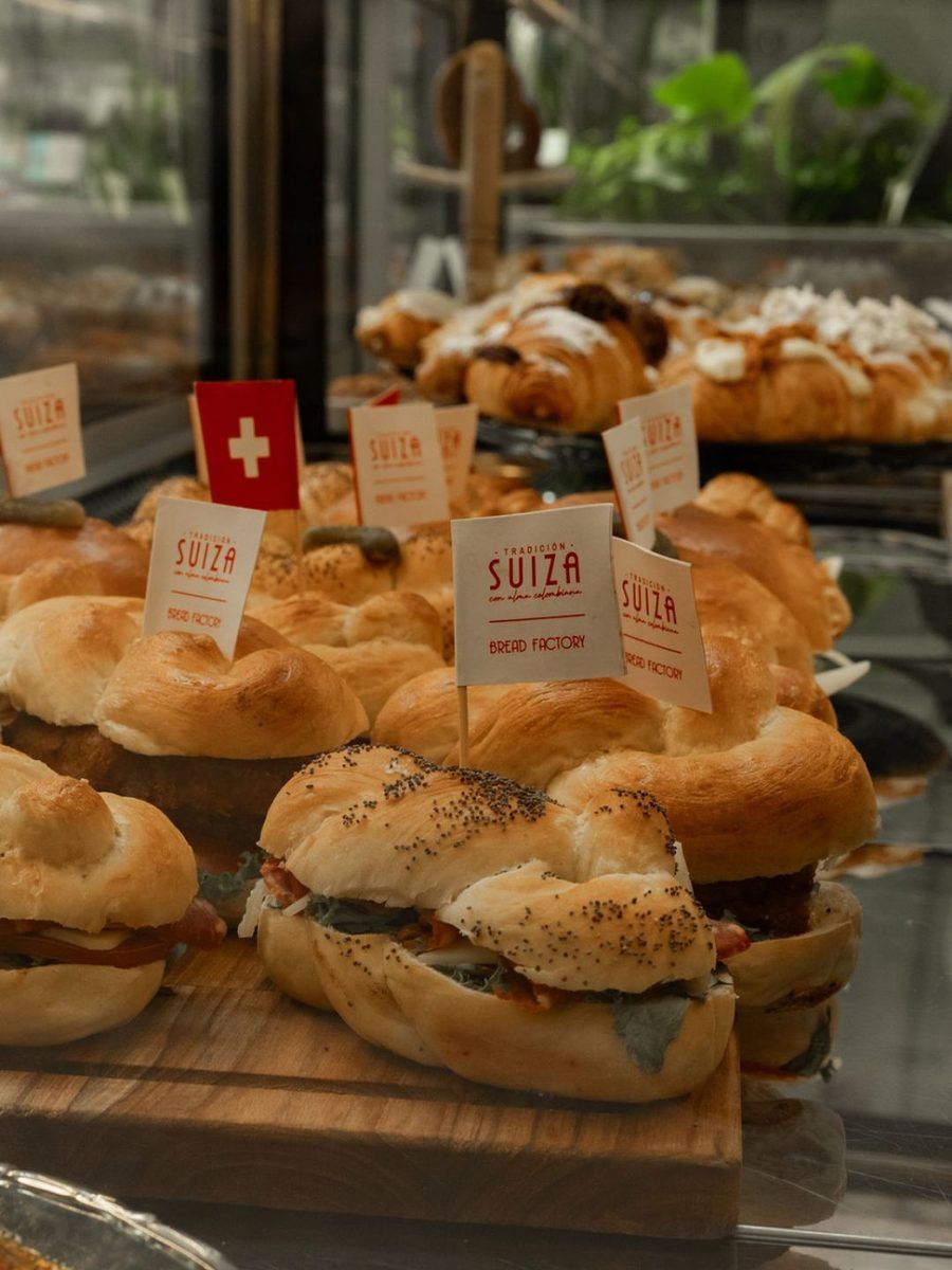 Rolls and sandwiches with small Swiss flags on the Bread Factory counter